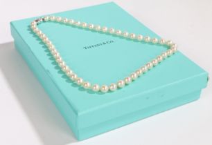 A Tiffany & Co cultured pearl single strand necklace, the 18 carat white gold reeded cross clasp,