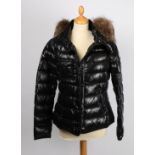 A Moncler 'wet look' padded short coat with fur lined collar,  size 3.