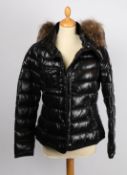 A Moncler 'wet look' padded short coat with fur lined collar,  size 3.