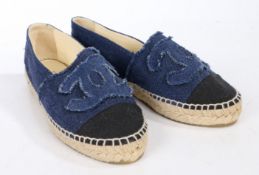 A pair of Chanel flat navy blue denim espadrilles with CC logo and beige leather lining. Size 35
