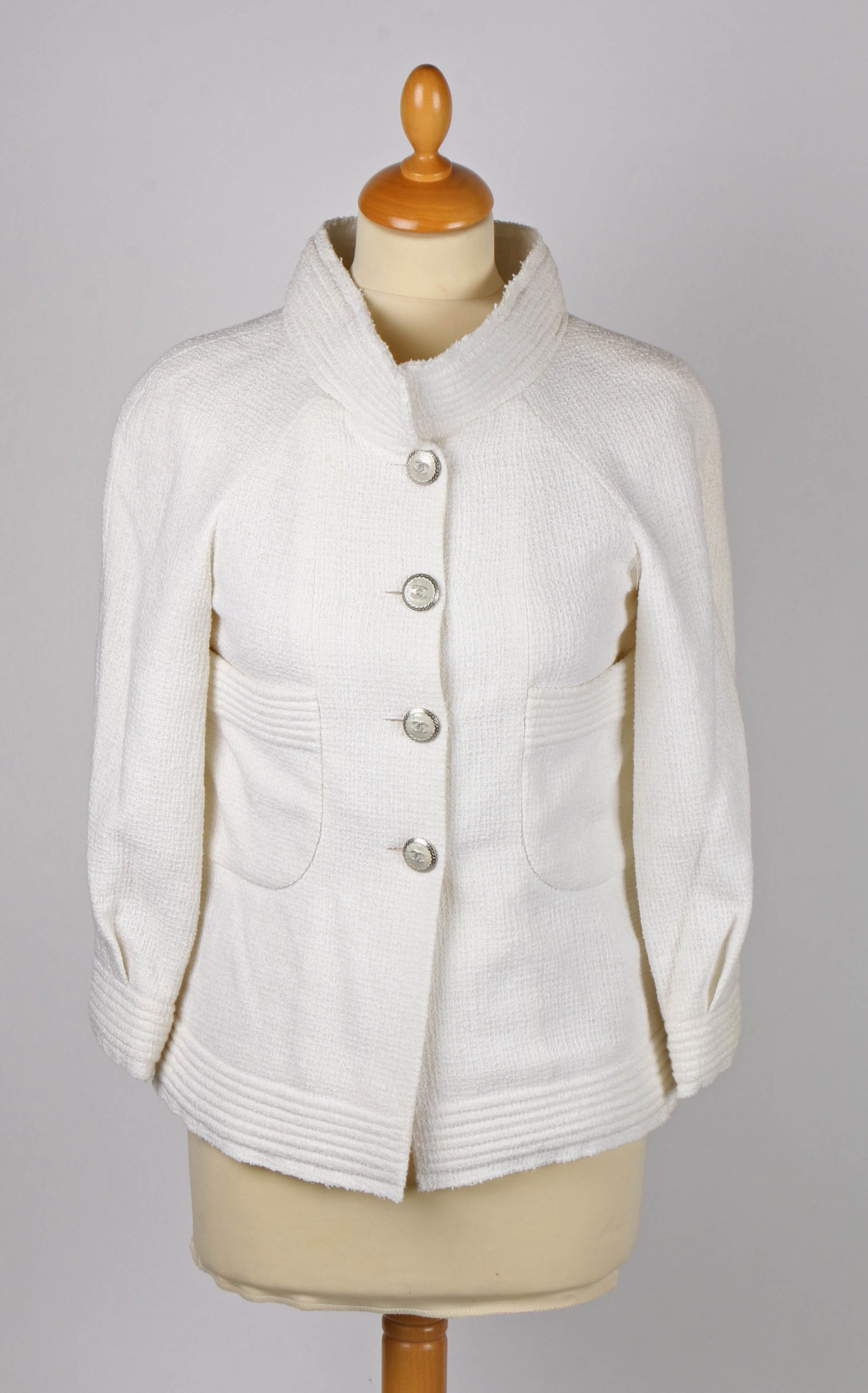 A Chanel white tweed single breasted jacket with pearlescent CC logo buttons. Size 34.