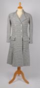 A Chanel monochrome tweed double-breasted knee length coat with lucite CC logo buttons, size 34.