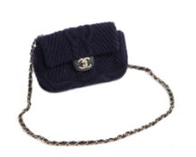 A Chanel navy blue cable knit small flap bag, the navy blue cable knit body with gilt CC twist