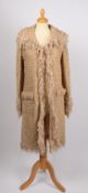 An Escada beige wool bouclé long jacket, size 36.