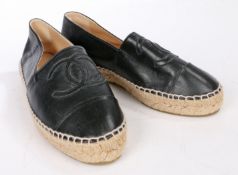 A pair of Chanel black leather flat espadrille type shoes with CC logo. Size 36