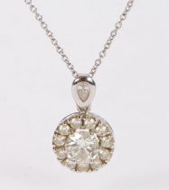 A 9 carat white gold and diamond pendant necklace, the pendant with central 1ct diamond surrounded