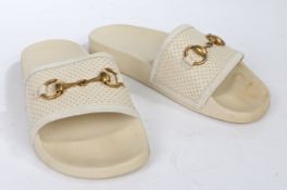 A pair of cream leather Gucci sliders with bronze 'horse bit' hardware. Size 35