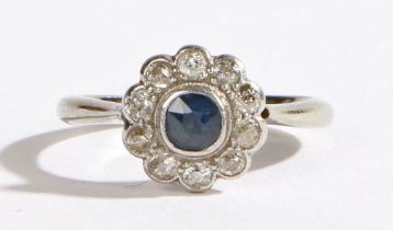 An 18 carat white gold, platinum, sapphire and diamond ring, the central round cut sapphire