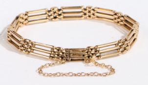 A 15 carat gold gate-link bracelet, with security chain, 16.8g