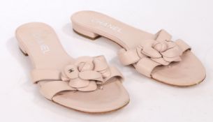 A pair of Chanel flat dusky pink flat leather sandals with camellia leather flower, size 36.