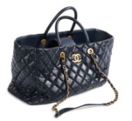 A Chanel Coco blue leather tote bag, the quilted body with Gilt CC emblem, arched handles, blue