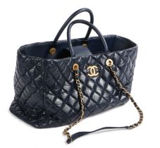 A Chanel Coco blue leather tote bag, the quilted body with Gilt CC emblem, arched handles, blue