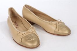 A pair of beige Chanel leather ballet flats with gold leather CC embroidered toe cap. Size 35.
