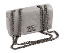 A Chanel Coco Boy small flap bag, with silver quilted leather exterior, the flap with CC push button