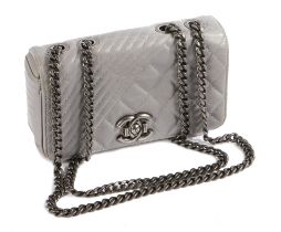 A Chanel Coco Boy small flap bag, with silver quilted leather exterior, the flap with CC push button