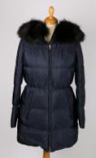 A Prada quilted coat with black fur hood, size 38.