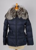 A Prada navy quilted jacket with grey fur trimmed hood, size 38