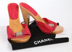 A pair of Chanel pink high heeled clog style slip on shoes with silver CC logo buckle. Size 36