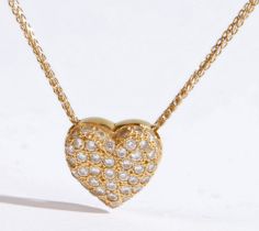 An 18 carat yellow gold pendant necklace, the pendant of heart form encrusted with round brilliant