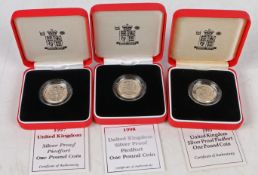 Three Royal Mint piedfort silver proof one pound coins, 1993, 1997 and 1998, cased with certificates