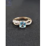 9 CARAT GOLD DIAMOND AND BLUE TOPAZ RING