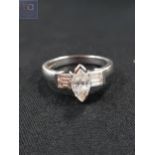 18 CARAT WHITE GOLD DIAMOND RING - MARQUISE CUT CENTRE STONE WITH 4 BAGUETTE CUT DIAMONDS TO SIDE.