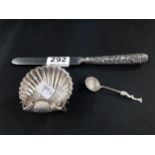 SILVER SHELL SHAPED SALT ON FISH FOOT WITH SPOON AND ORNATE SILVER HANDLED KNIFE