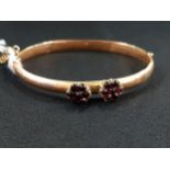 ANTIQUE 9 CARAT GOLD BANGLE WITH GARNET FLOWERS 6.1G