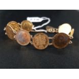 BRACELET COMPRISING 7 X HALF SOVEREIGNS AND 9 CARAT GOLD LINKS WATCH CHAIN (COMPRISING 4 SHIELD