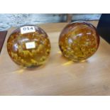PAIR OF COLOURED GLASS PAPERWEIGHTS