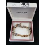 14 CARAT GOLD PANDORA BRACELET WITH GOLD AND SILVER CHARMS