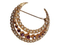 9 CARAT GOLD CRESCENT MOON BROOCH IN THE ANTIQUE STYLE SET WITH GARNET & SEED PEARL CIRCA 10 GRAMS