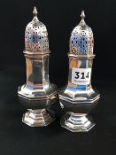 TWO SILVER SUGAR SIFTERS BOTH HALLMARKED FOR SHEFFIELD 16CMS HIGH - 222.8 GRAMS