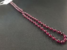ANTIQUE CHERRY AMBER NECKLACE WITH 9 CARAT GOLD CATCH