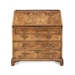 A George II walnut and featherbanded bureau Circa 1730