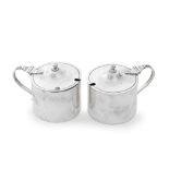 A pair of silver drum mustard pots Goldsmiths & Silversmiths Co Ltd, London 1925 and 1926 (2)