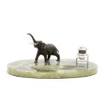 A early 20th century patinated bronze elephant and green onyx desk stand retailed by Rowland War...