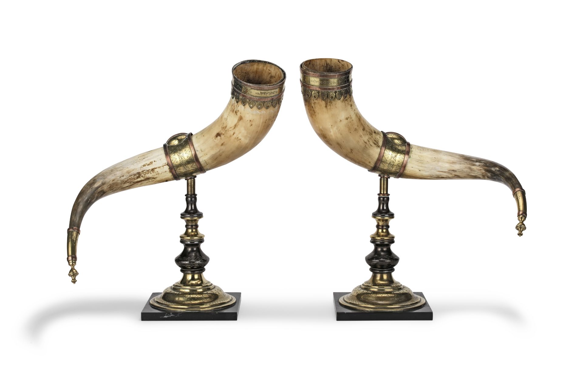 A pair of late 19th Century patinated and polished brass and copper mounted cow horn garniture o...