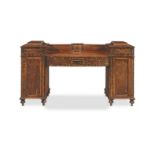 A Regency mahogany, calamander and ebonised inlaid pedestal sideboard in the manner of George Oa...