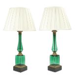 A pair of mid 20th century gilt brass mounted and moulded green glass table lamps in the Empire ...