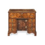 A George I walnut and featherbanded kneehole desk Circa 1725