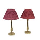 A pair of Louis Philippe gilt bronze candlesticks later adapted as lamp bases (4)