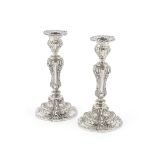 A pair of French Rococo style silver candlesticks maker's mark Edmond T&#233;tard for T&#233;tar...