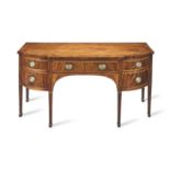 A George III mahogany, satinwood banded and inlaid breakfront D-shaped sideboard Circa 1790