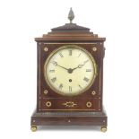 An early 19th century mahogany and brass inlaid bracket timepiece