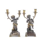 A pair of late 19th century gilt and patinated bronze figural candelabra in the manner of Claud...