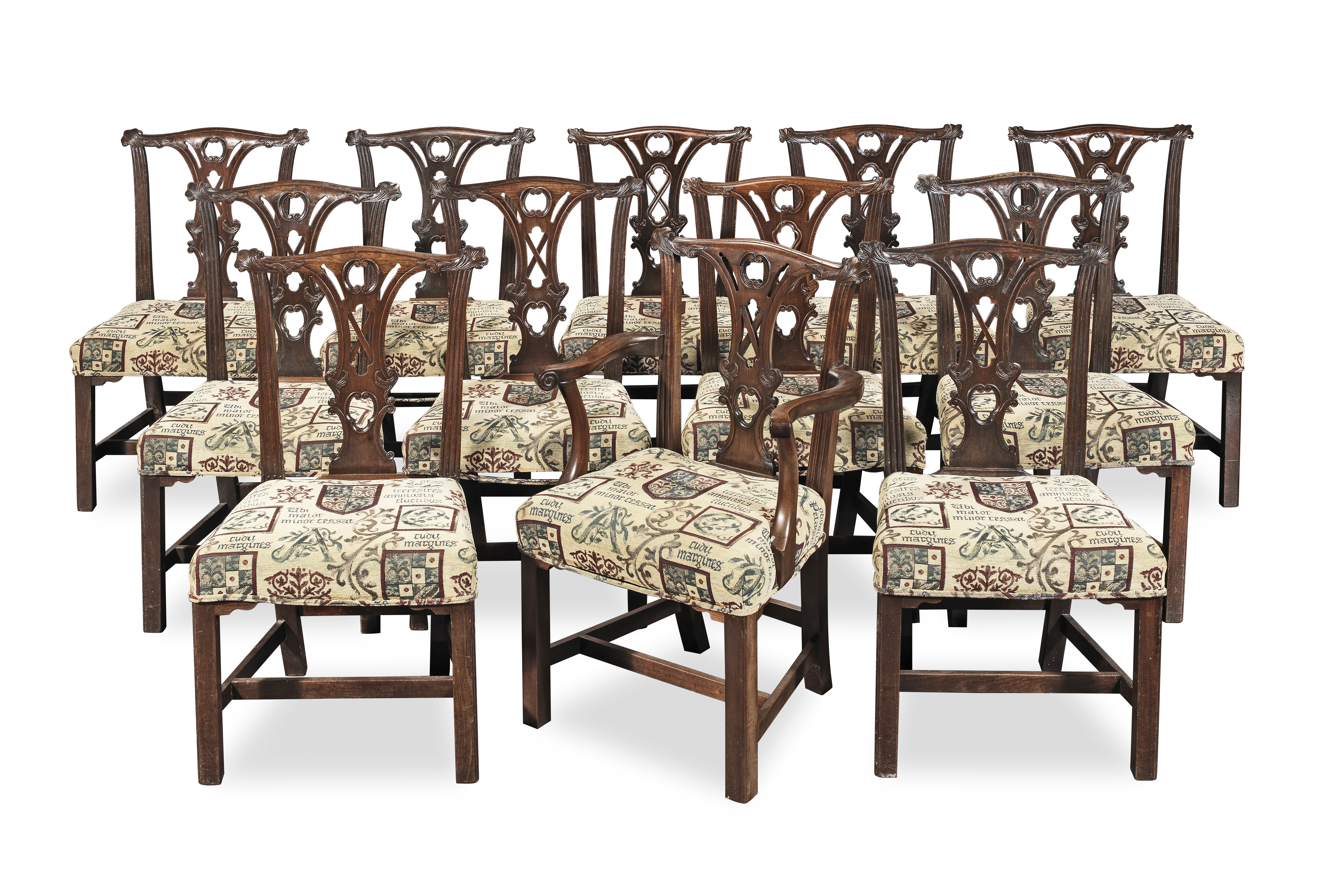 A matched set of twelve carved mahogany dining chairs at least five of the chairs are late 18th...