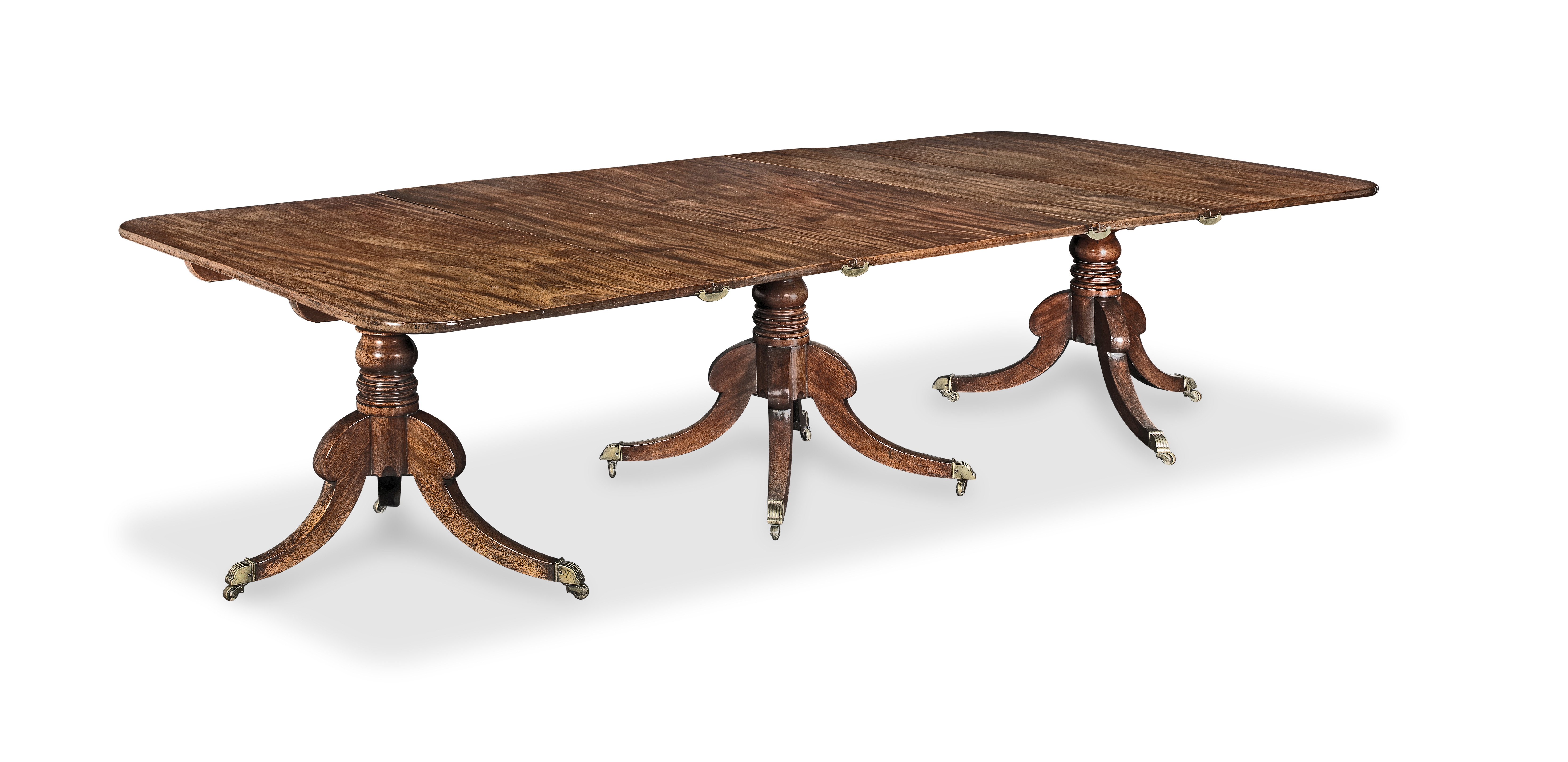 An early 19th century mahogany triple pedestal dining table