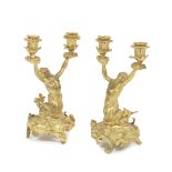 A pair of mid 19th century French gilt bronze twin-light figural candelabra in the manner of Re...