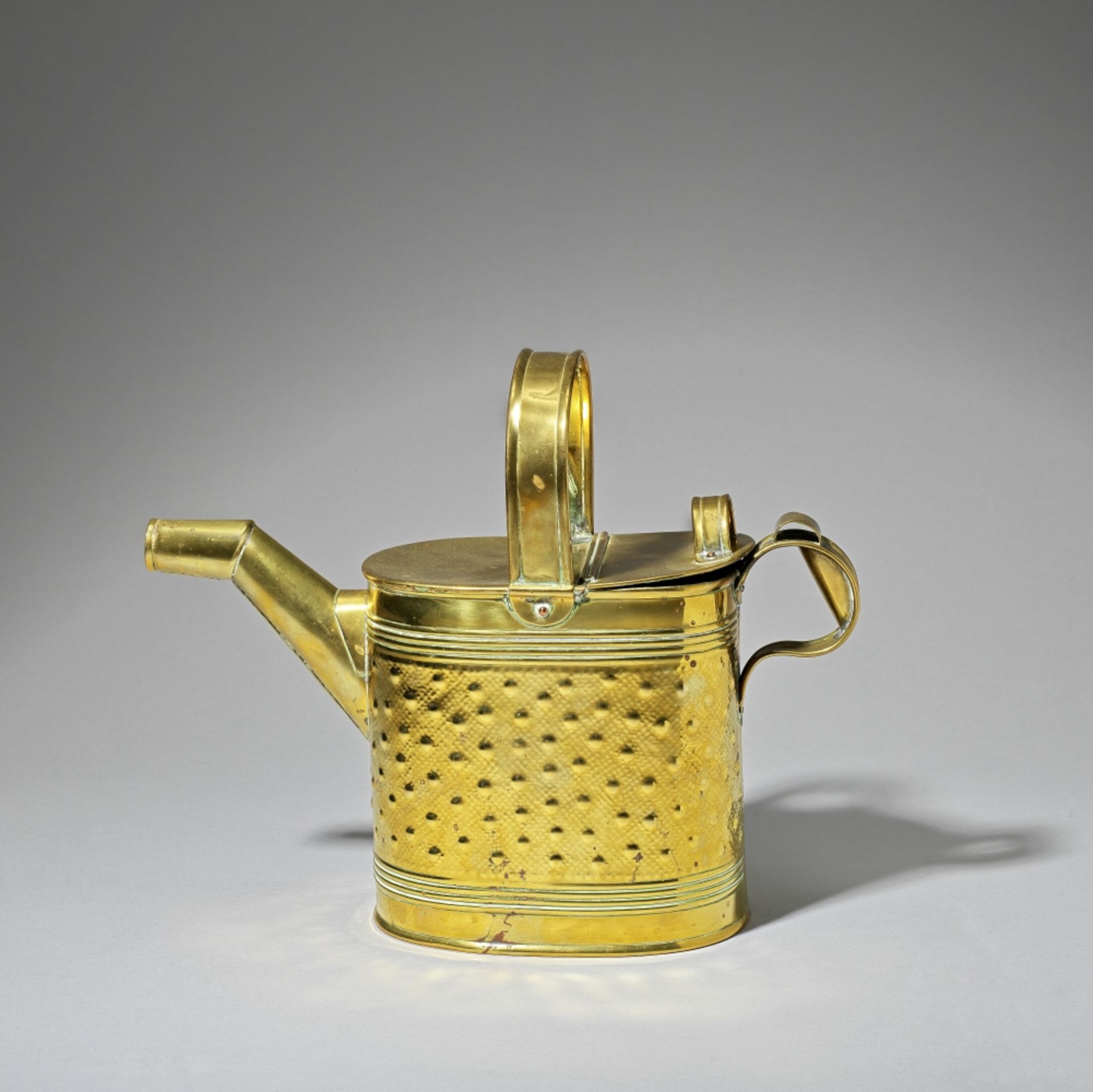 R. Perry & Sons: After a design by Dr Christopher Dresser Watering can, circa 1890Brass, with an...